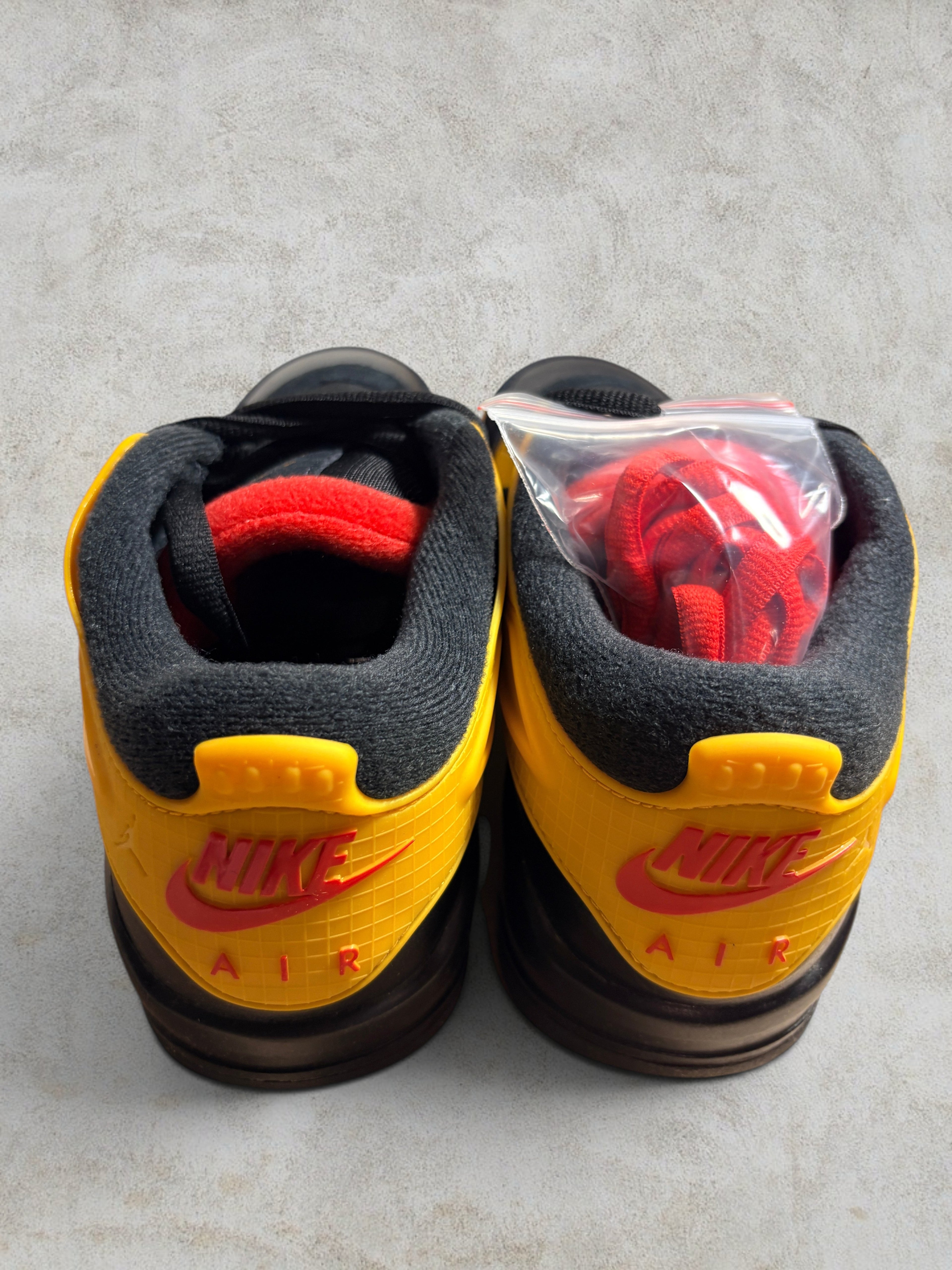 Air Jordan 4 RM "Bruce Lee" – Black / Del Sol (Neuf)