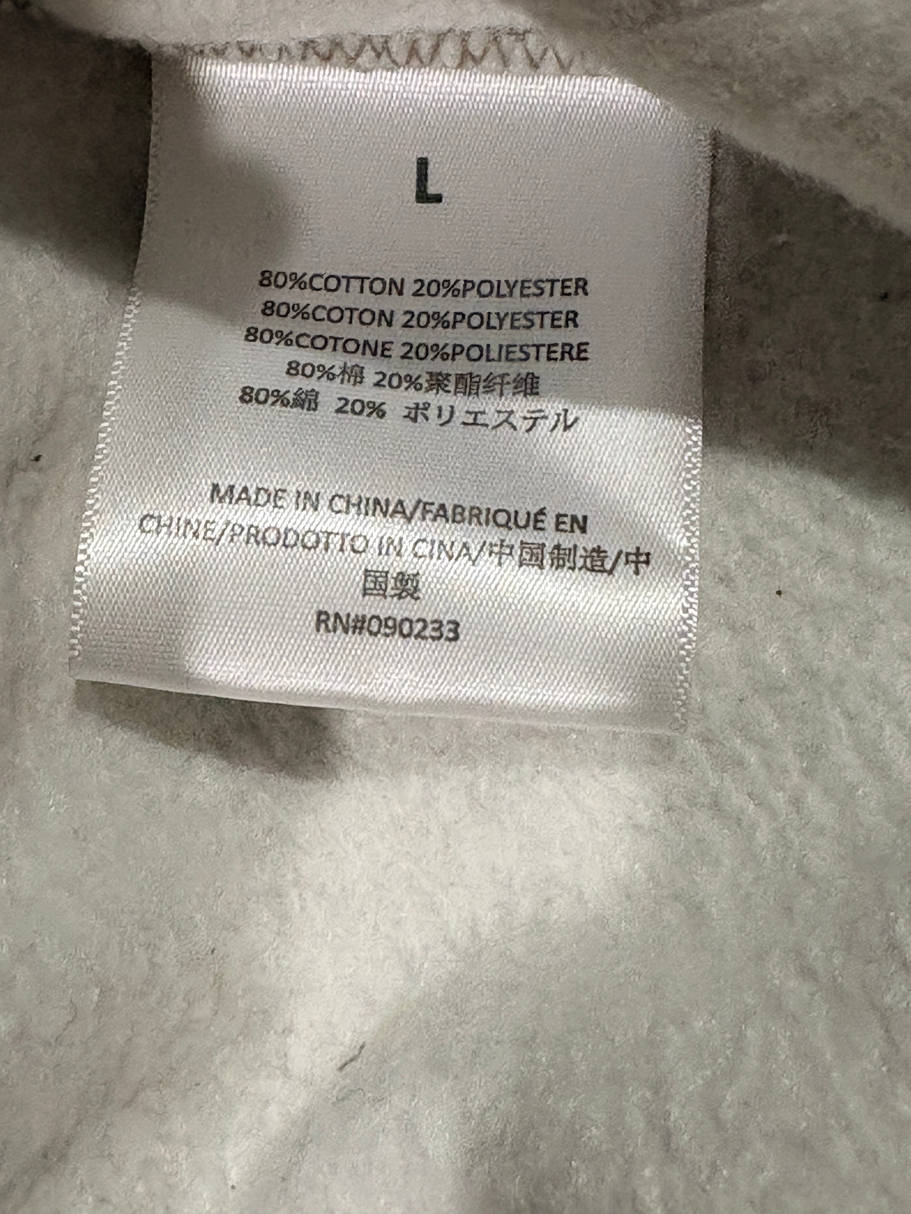 Étiquette de composition intérieure du pantalon Fear of God ESSENTIALS 1977 chez FASHION SC indiquant 80% coton